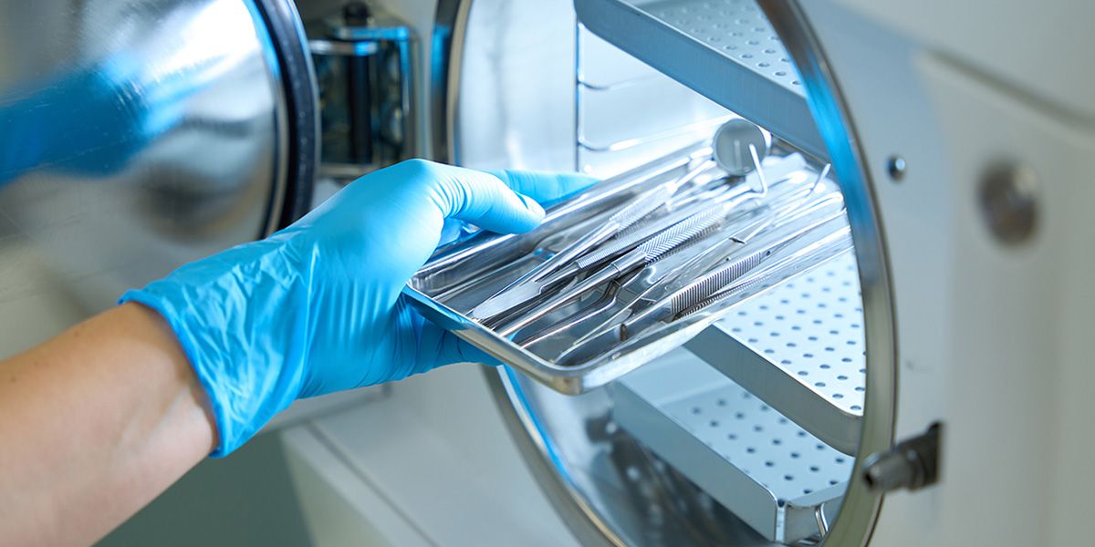 Sterile processing technician handling medical equipment